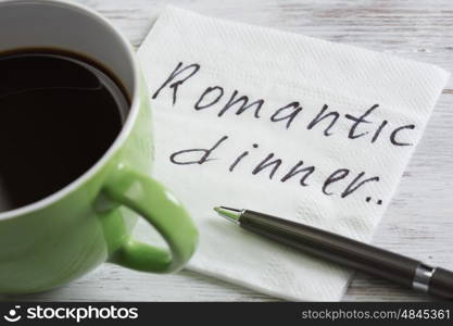 Love confession on napkin. Romantic message written on napkin and cup of coffee on wooden table