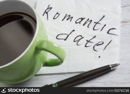 Love confession on napkin. Romantic message written on napkin and cup of coffee on wooden table