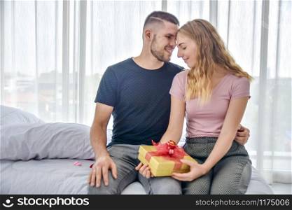 Love Couple giving gift box in bedroom happiness in love Valentine&rsquo;s day concept