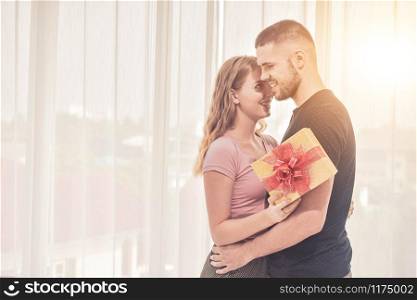 Love Couple giving gift box in bedroom happiness in love Valentine?s day concept