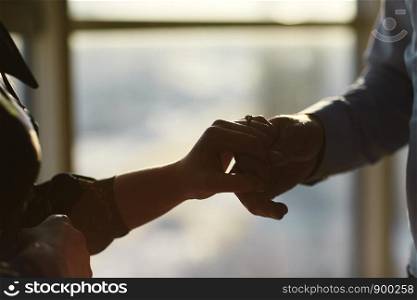 love, couple, relationship and holidays concept - close up of man giving diamond ring to woman. hands of a young couple with a ring. hands of a young couple with a ring. love, couple, relationship and holidays concept - close up of man giving diamond ring to woman