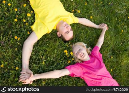 love couple resting on the green grass