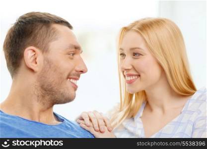 love, family and happiness concept - smiling happy couple at home