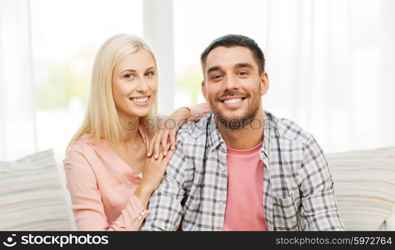 love, family and happiness concept - smiling happy couple at home