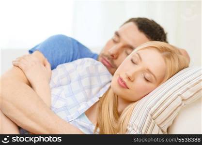 love, family and happiness concept - smiling happy couple sleeping at home
