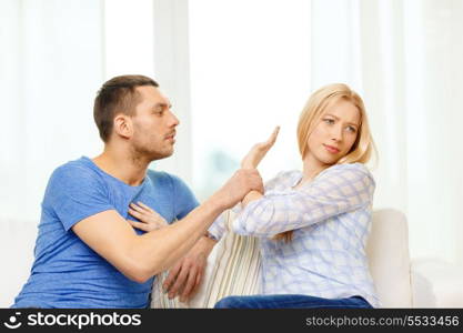 love, family and happiness concept - unhappy couple having argument at home