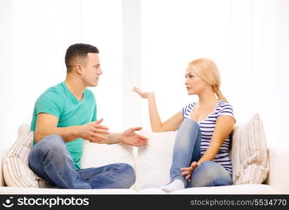 love, family and happiness concept - unhappy couple having argument at home