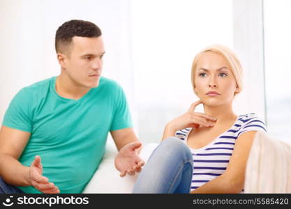 love, family and happiness concept - unhappy couple having argument at home