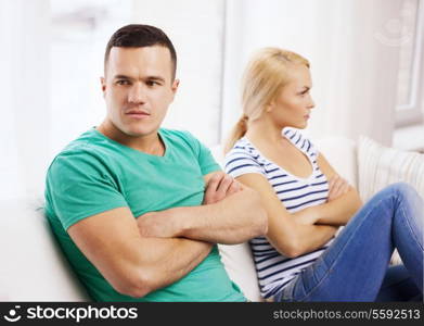 love, family and happiness concept - unhappy couple not speaking after having argument at home