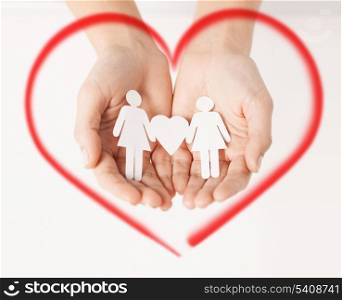 love, family and happiness concept - womans hands showing two paper women with heart shape