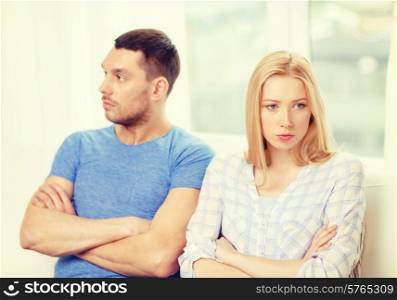 love, family and relationship problems concept - unhappy couple not speaking after having argument at home