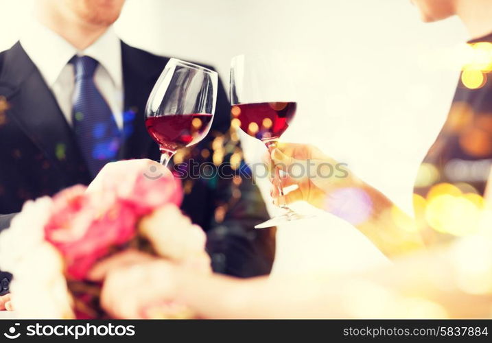 love, family, anniversary concept - engaged couple with wine glasses in restaurant