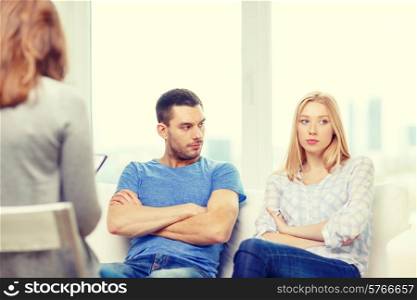 love, family, phychology and relationship problems concept - young couple with a problem at psychologist office