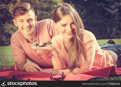 Love food and happiness. Smiling joyful cute couple on picnic in garden park. Happy lovers dating on fresh air.. Couple on picnic date outdoor.