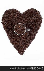 Love for coffee beans. a heart sign made out of coffee beans with a cup or mug full of beans in the middle