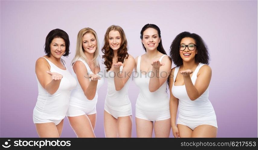 love, friendship, beauty, body positive and people concept - group of happy plus size women in white underwear sending blow kiss over violet background