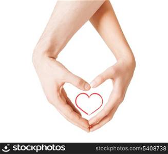 love, happiness and family concept - close up of woman and man hands showing heart shape