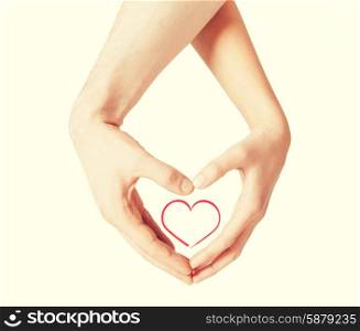 love, happiness and family concept - close up of woman and man hands showing heart shape