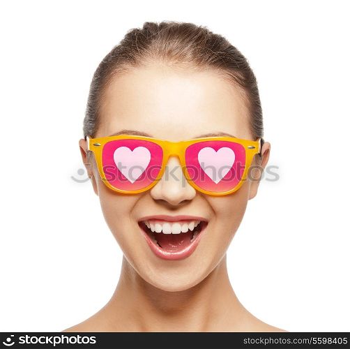 love, happiness and people concept - portrait of happy teenage girl in shades with hearts
