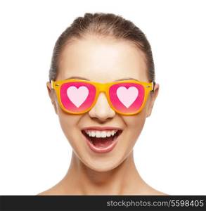 love, happiness and people concept - portrait of happy teenage girl in shades with hearts