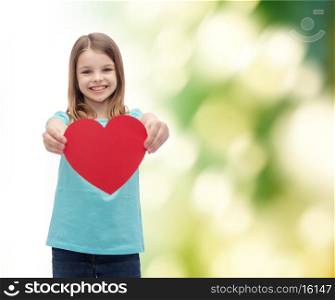 love, happiness and people concept - smiling little girl giving red heart