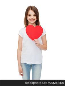 love, happiness and people concept - smiling little girl with red heart