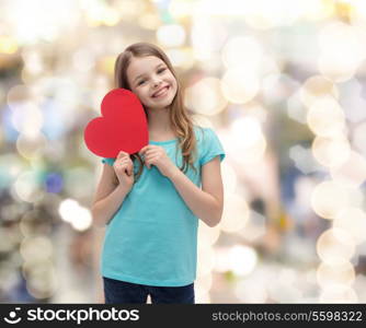 love, happiness and people concept - smiling little girl with red heart