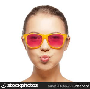 love, happiness, valentines day, face expressions and people concept - portrait of teenage girl in pink sunglasses blowing kiss