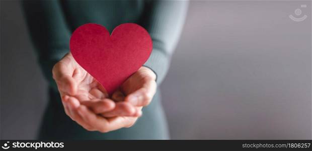 Love, Health Care, Donation and Charity Concept. Close up of Volunteer Holding a Heart Shape Paper