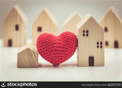 Love heart between big and small house model for stay at home love together and healthy community concept.