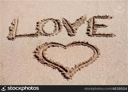 Love holiday. Painted heart on beach sand