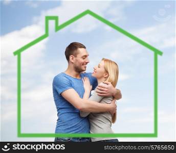love, home, people and family concept - smiling couple hugging and looking to each other over green house and blue sky background background