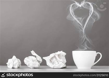 love letter. crumpled wads and heart silhouette on gray