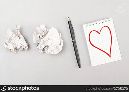 love letter. crumpled wads and notebook with heart picture