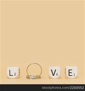 love letter made with wedding diamond rings cubes cream background