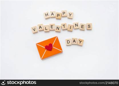 Love letter, red heart, wood lettering Happy Valentine&rsquo;s Day. Valentine&rsquo;s Day celebration concept. Love letter, red heart, wood lettering Happy Valentine&rsquo;s Day. Valentine&rsquo;s Day celebration concept.