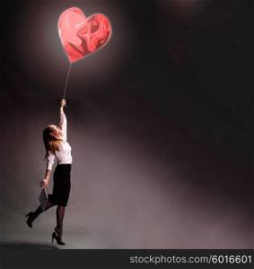 Love lifts up. Business woman is flying away with love inspiration