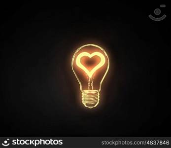 Love light. Heart shape in light bulb on black background