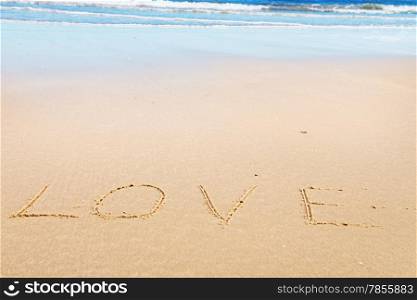 Love message on the beach sand - love and romantic concept