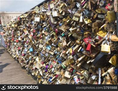 Love padlocks on Bridge of arts in Paris, France