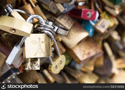 Love padlocks on the bridge Pont des Arts across river Seine in Paris, France