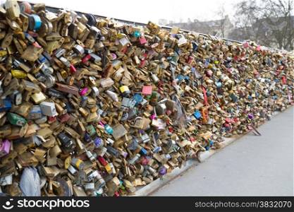 Love padlocks on the bridge Pont des Arts across river Seine in Paris, France