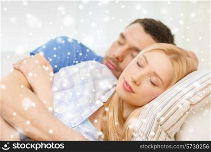 love, people and family concept - sleeping couple lying on sofa and hugging at home