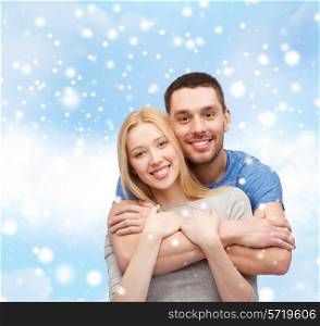 love, people and family concept - smiling couple hugging over blue sky, snow and cloud background