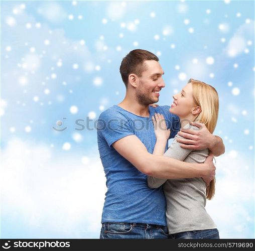 love, people and family concept - smiling couple hugging over blue sky, snow and cloud background