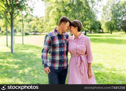 love, people and relationships concept - happy couple in summer park. happy couple in summer park