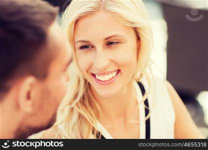 love, people, communication and relations concept - happy couple faces at restaurant looking at each other