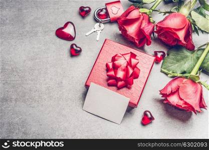 Love Red gift box with roses and blank paper card , heart and lock and key, top view. Mock up for greeting for Mothers day, Birthday or Valentine?s Day