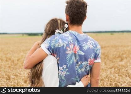 love, relationship and people concept - happy hippie couple hugging over cereal field. smiling young hippie couple over minivan car