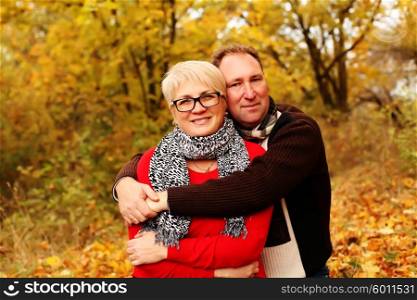 Love, relationship, family, age, tourism, travel and people concept - close up of couple kissing in autumn park